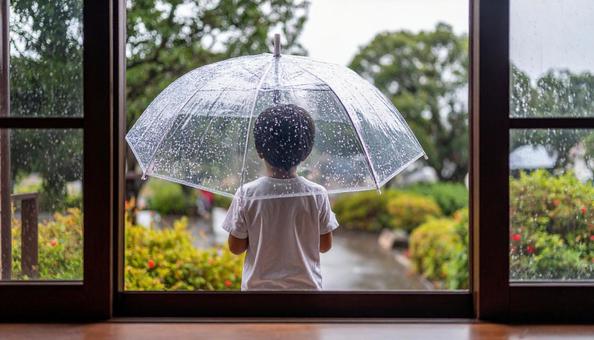 傘を差した子供の写真