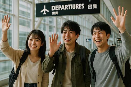 空港の出発口で手を振る日本の友人グループ 空港の出発口で手を振る日本の友人グループの写真