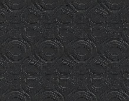黒いワックスの円形レリーフ模様の写真