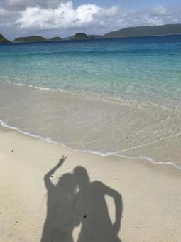 Shadows of two people reflected on the sandy beach, sea, wave, sky, JPG