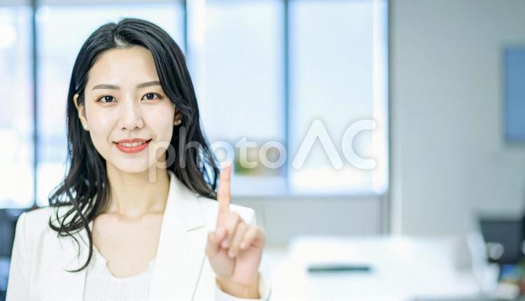 自信のある表情で指さすビジネス女性 指さす,指差し,ビジネスの写真素材
