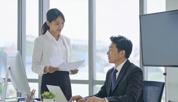 上司に報告する女性社員 上司に報告する女性社員の写真