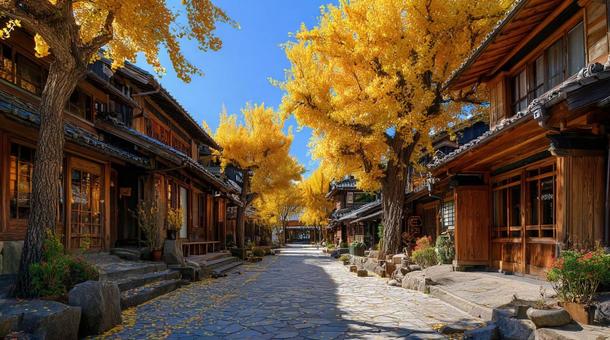 黄金のイチョウ並木と日本の街並みの写真