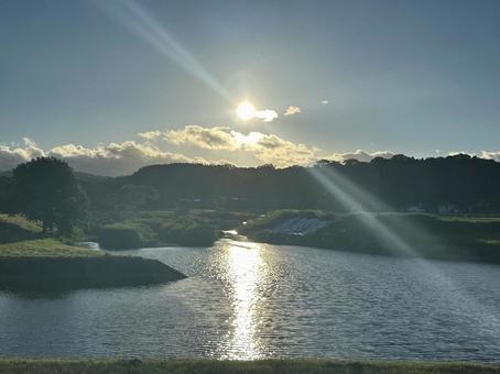 A clear summer morning sun shining straight across the water surface, JPG A clear summer morning sun shining straight across the water surface, JPG