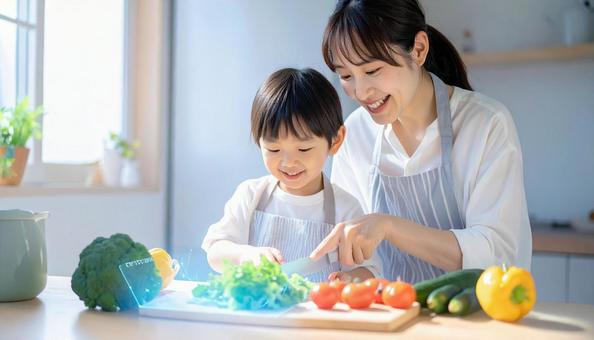 ホログラムで野菜の切り方を学ぶ親子 ホログラムで野菜の切り方を学ぶ親子の写真