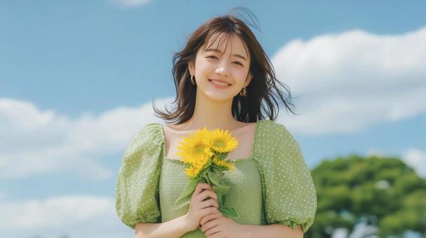 ひまわりと緑色のワンピースを着た女性 ひまわりと緑色のワンピースを着た女性の写真