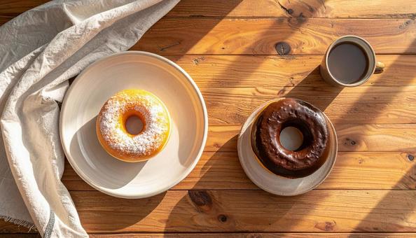 陽だまりのテーブルと2つのドーナツの写真