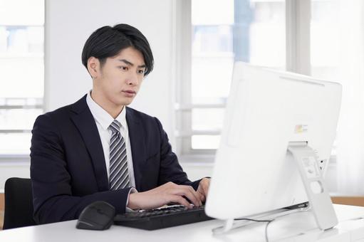 Japanese male businessman working on a computer with a serious expression, JPG Japanese male businessman working on a computer with a serious expression, business, office, businessman, JPG