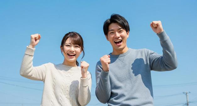 ガッツポーズをとる男女 ガッツポーズをとる男女の写真