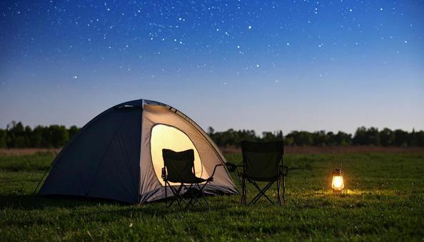 夜の星空の下の焚き火とテントキャンプ 夜の星空の下の焚き火とテントキャンプの写真