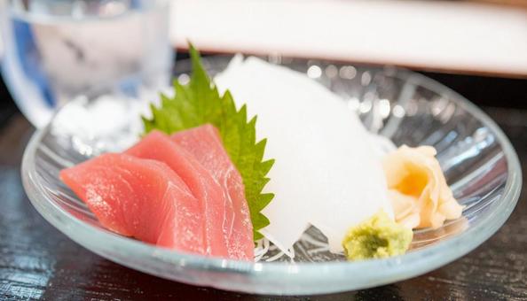 ガラスの皿に盛られた刺し身と日本酒 ガラスの皿に盛られた刺し身と日本酒の写真