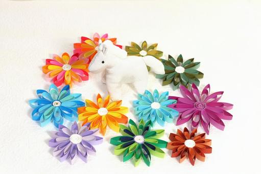 カラフルな紙の花に囲まれたちりめんの白馬 年賀状,午年,白馬の写真素材