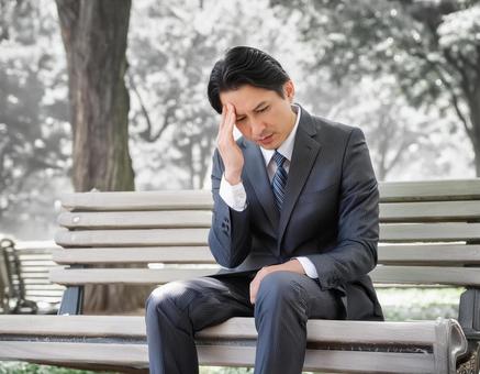 リストラで途方にくれるサラリーマンの写真