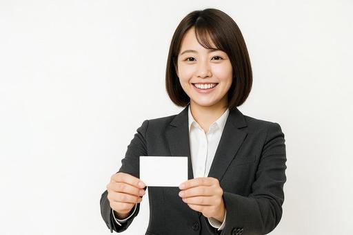 笑顔で名刺を差し出す営業女子 笑顔で名刺を差し出す営業女子の写真