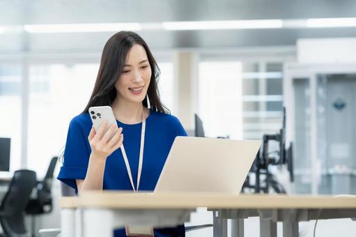オフィスカジュアルの若い女性エンジニア オフィスカジュアルの若い女性エンジニア ビジネス,女性,スマホの写真素材