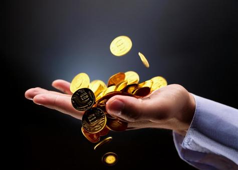 金貨を受け止める手 金貨を受け止める手の写真
