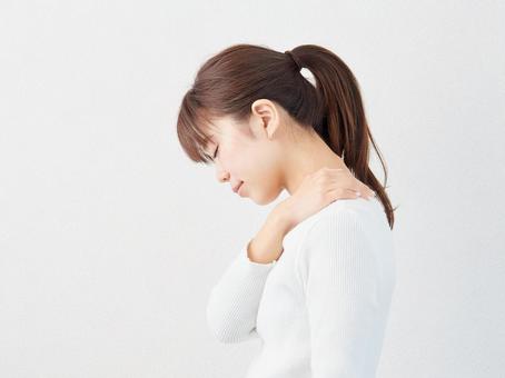 Image of a woman with stiff shoulders Image of a woman with stiff shoulders