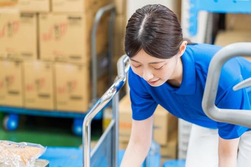 A woman working in a warehouse., JPG