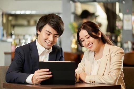 Asian couple ordering from tablet menu Asian couple ordering from tablet menu