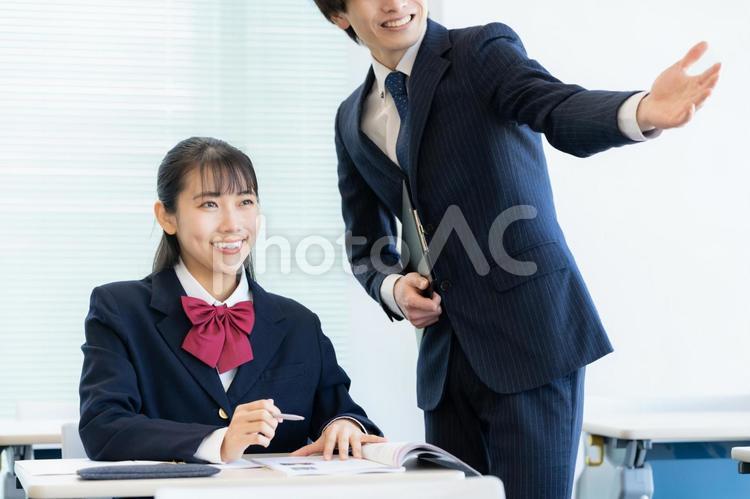 学校で勉強を教える先生と女子高生 塾,教育,勉強の写真素材
