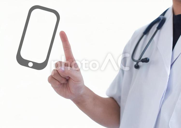 指差す白衣の男性とスマホ 医者,医師,聴診器の写真素材