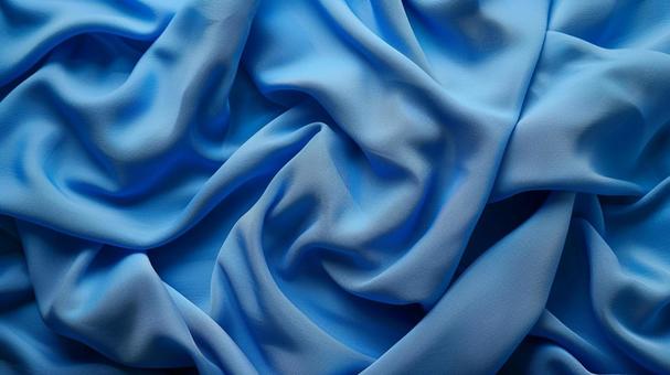 青い布のシワと光沢テクスチャ背景の写真