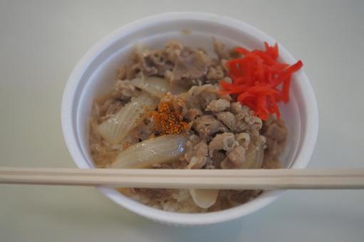 Beef bowl in a disposable container and disposable chopsticks, JPG
