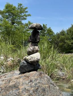 山梨の河原で石を積む 山,空,砂の写真素材