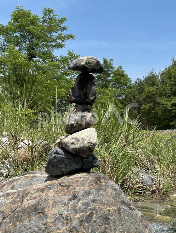 山梨の河原で石を積む 山,空,砂の写真素材