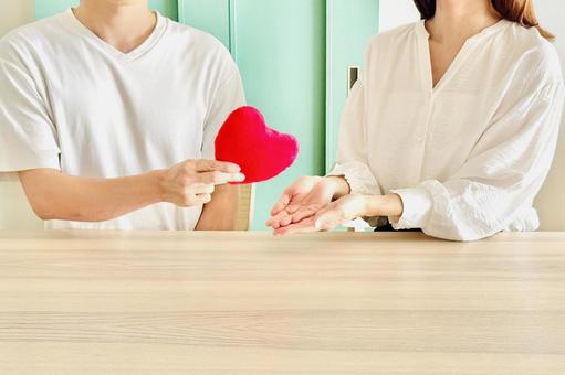 Image of a man giving a heart to a woman, JPG Image of a man giving a heart to a woman, JPG