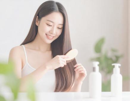 ヘアケア中の女性 ヘアケア中の女性の写真