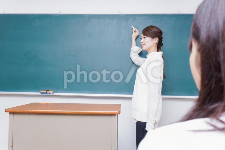 学校で授業をする教師 女子生徒,義務教育,教室の写真素材