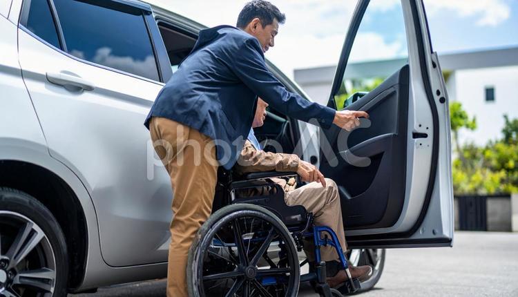 車椅子高齢男性の車の乗車を介助する男性 車,肢体不自由,介護の写真素材
