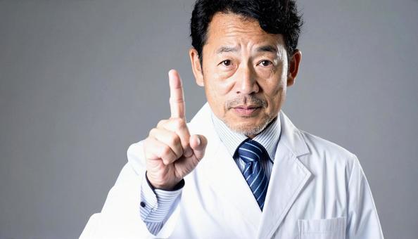 注意! 人差し指を立てる白衣を着た男性 注意! 人差し指を立てる白衣を着た男性の写真