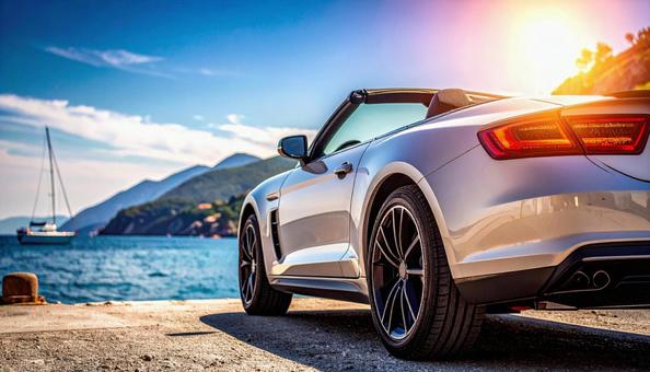 海が見える埠頭に止められたオープンカー の写真