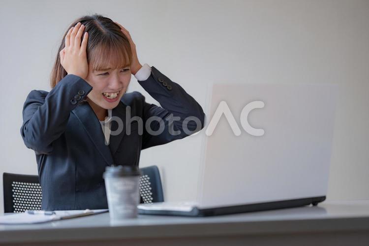 頭を抱えるビジネスウーマン 女性,ビジネスウーマン,ビジネスマンの写真素材