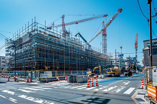A large construction project with scaffolding and heavy machinery, construction site, intersection, heavy equipment, JPG