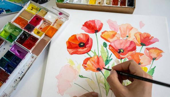 スケッチブックに花の絵を描く人の手もと スケッチブックに花の絵を描く人の手もとの写真
