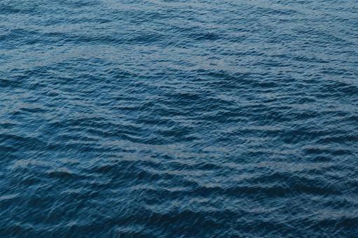 穏やかな海面、夕暮れに映えるブルーの波紋 穏やかな海面、夕暮れに映えるブルーの波紋 海,波,水面の写真素材