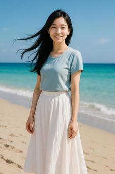 夏の海風に髪をなびかせる女性青ブラウス 夏の海風に髪をなびかせる女性青ブラウスの写真