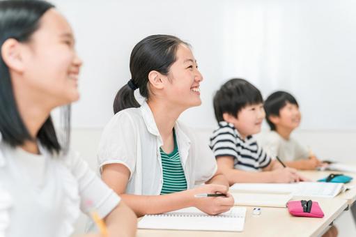 塾・学校で笑顔で授業を受ける小学生の男女 塾・学校で笑顔で授業を受ける小学生の男女 塾,学校,授業の写真素材
