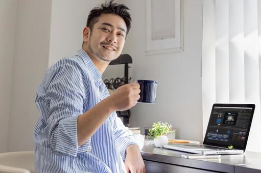 コーヒーを飲む動画クリエイター コーヒーを飲む動画クリエイター ビジネスマン,ノートパソコン,リモートワークの写真素材