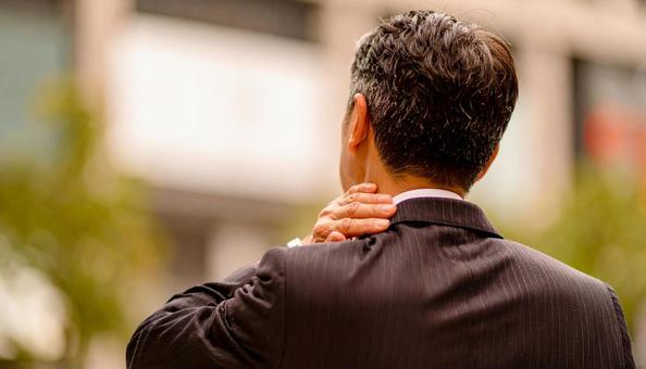 寝違えて首痛に苦しむ男性の写真