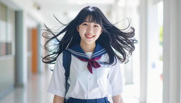 通学で風に髪が揺れる女子高校生 通学で風に髪が揺れる女子高校生の写真