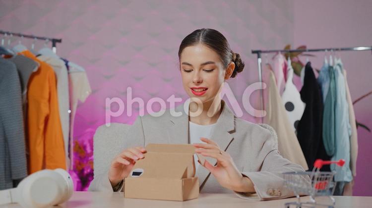 ギフトボックスを少しだけ開けて覗く女性 女性,人物,インフルエンサーの写真素材