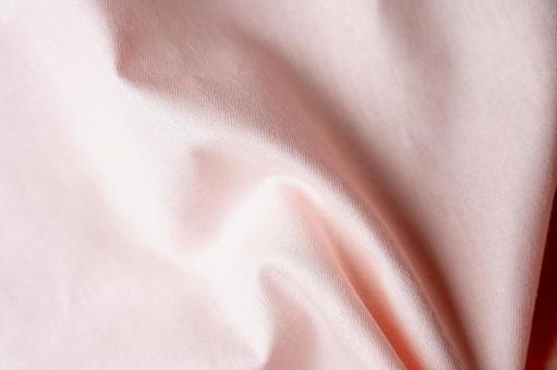 ピンク布のしわテクスチャ背景の写真