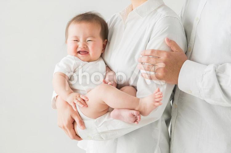 両親に抱かれる赤ちゃん（笑顔） 赤ちゃん,夫婦,両親の写真素材