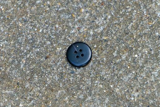 Black button on the asphalt, JPG