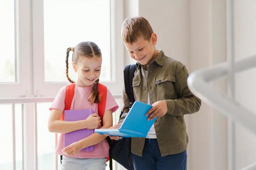 階段の踊り場でノートを見せる生徒たち 男の子,女の子,子どもの写真素材