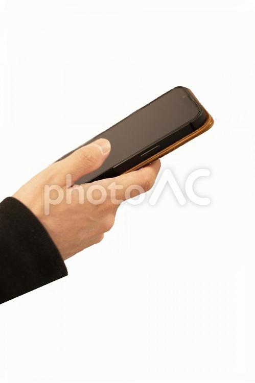 スマホを持つ手、縦画像 スマホ,操作,手の写真素材